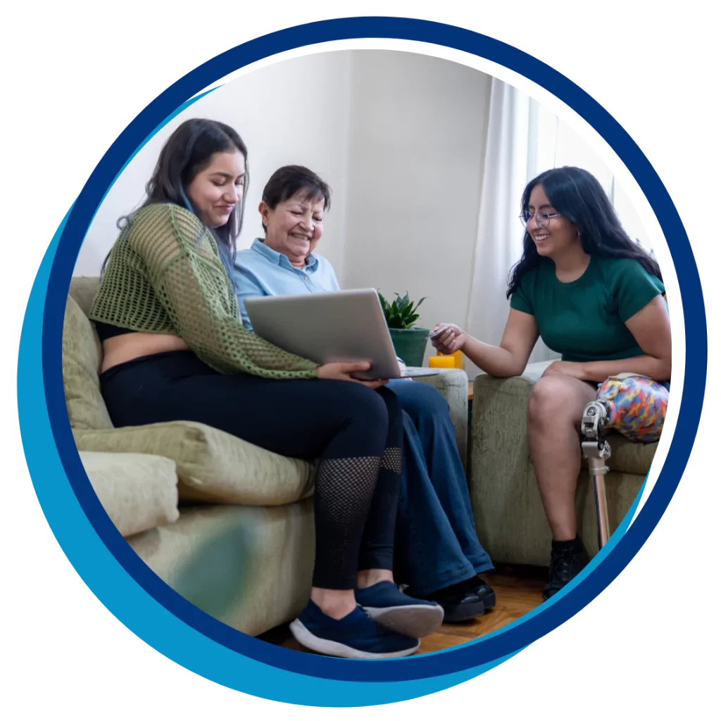 A family are smiling while using a laptop to make a referral